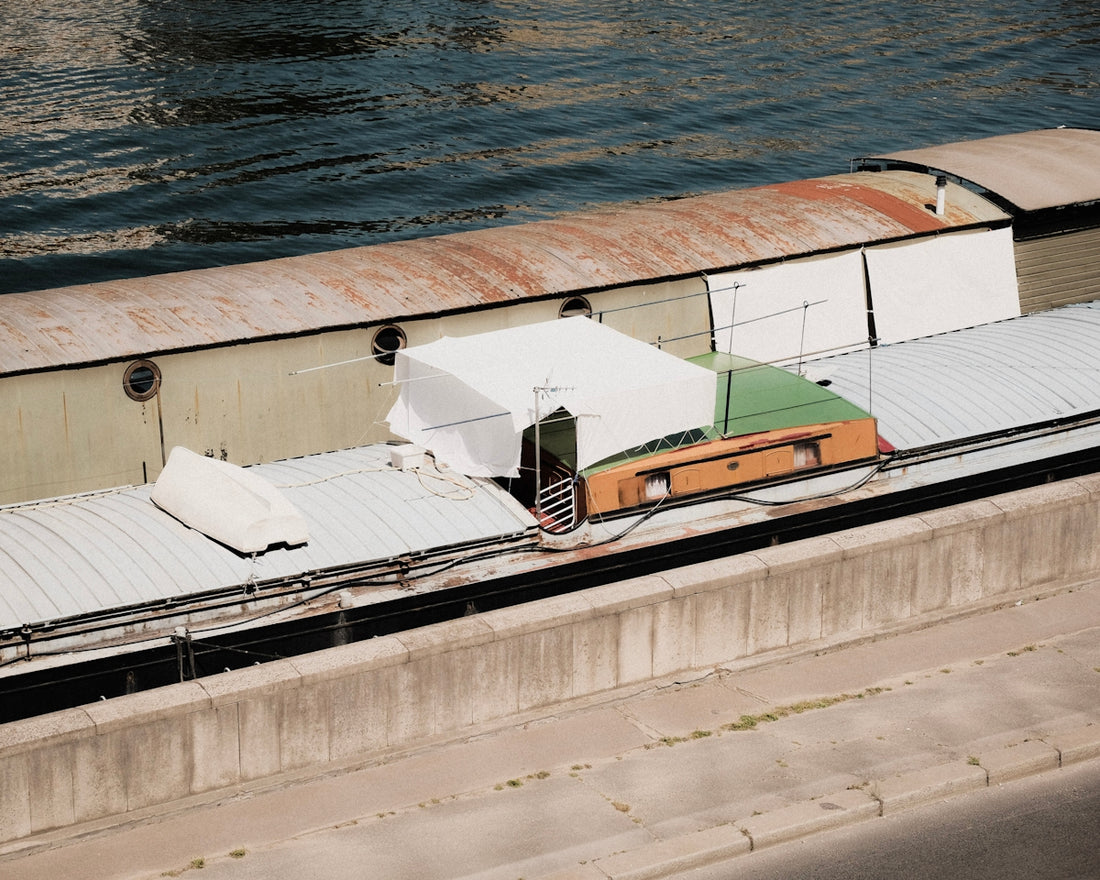 a building with a body of water in the background