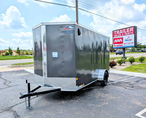 6X12 Enclosed trailer parked on a paved surface with a clear sky at AAA Trailer in Howell mi