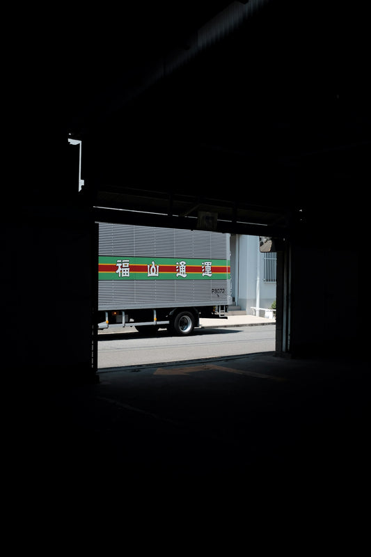 truck near opened roller shutter