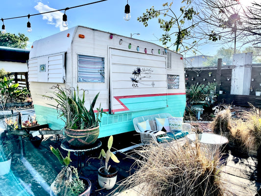 a trailer parked in a backyard next to a pool