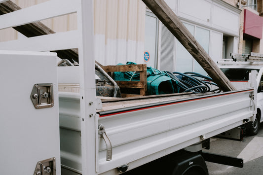 a white truck with a bunch of items in the back