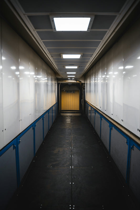 a long narrow hallway with a yellow door
