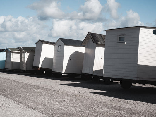 a row of beach huts sitting next to each other