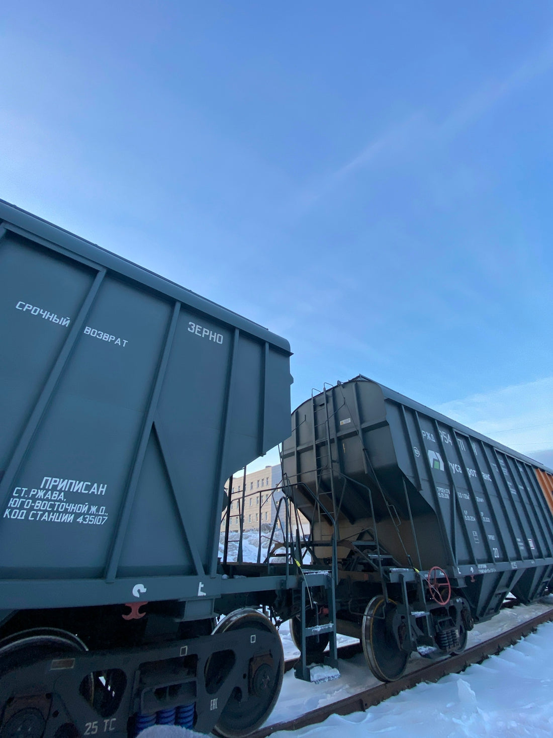a train car sitting on the tracks in the snow