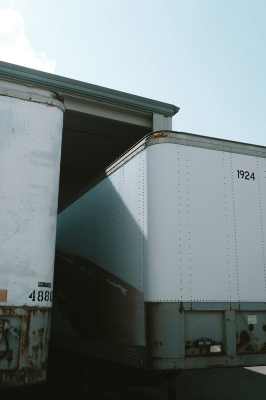 two semi trucks are parked next to each other