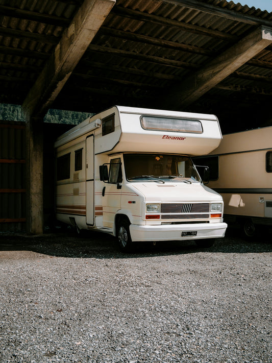 A couple of rvs parked in a garage