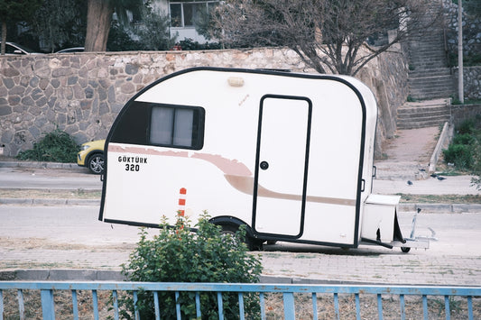 A white trailer parked on the side of a road