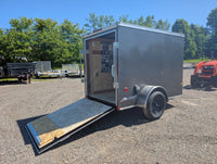 2026 American Hauler Arrow 5x8 Enclosed Cargo Trailer Pewter – front passenger-side 3/4 view, rear ramp door open, ready to load