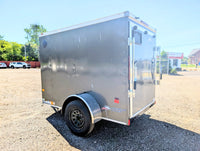 2026 American Hauler Arrow 5x8 Enclosed Cargo Trailer Pewter – rear driver-side 3/4 view, charcoal exterior, barn door hinges visible
