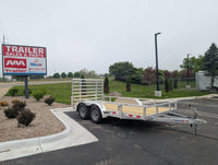 Silver Ox Utility trailer parked in a lot with a 'AAA Trailer Sales & Parts' sign in the background.