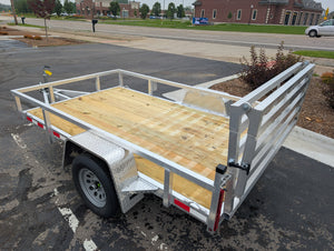 Silver Ox  6x10 Aluminum utility trailer w folding gate and wooden platform on a paved area