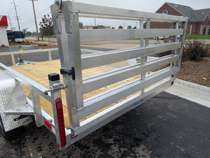 Metal trailer with wooden platform on a paved surface