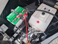 Close-up of a Griffin Dump  Trailer battery and fuel tank with visible connections at AAA Trailer