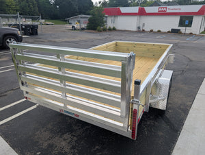 Aluminum utility trailer with wooden floor in a parking lot