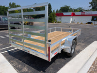 Aluminum Silver Ox utility trailer with wooden floor in a parking lot at AAA Trailer In Howell Mi