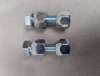 Two metal bolts on a textured gray background
