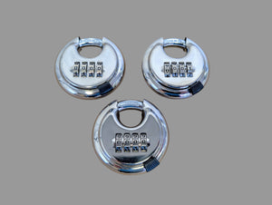 Three metallic combination locks on a cardboard background