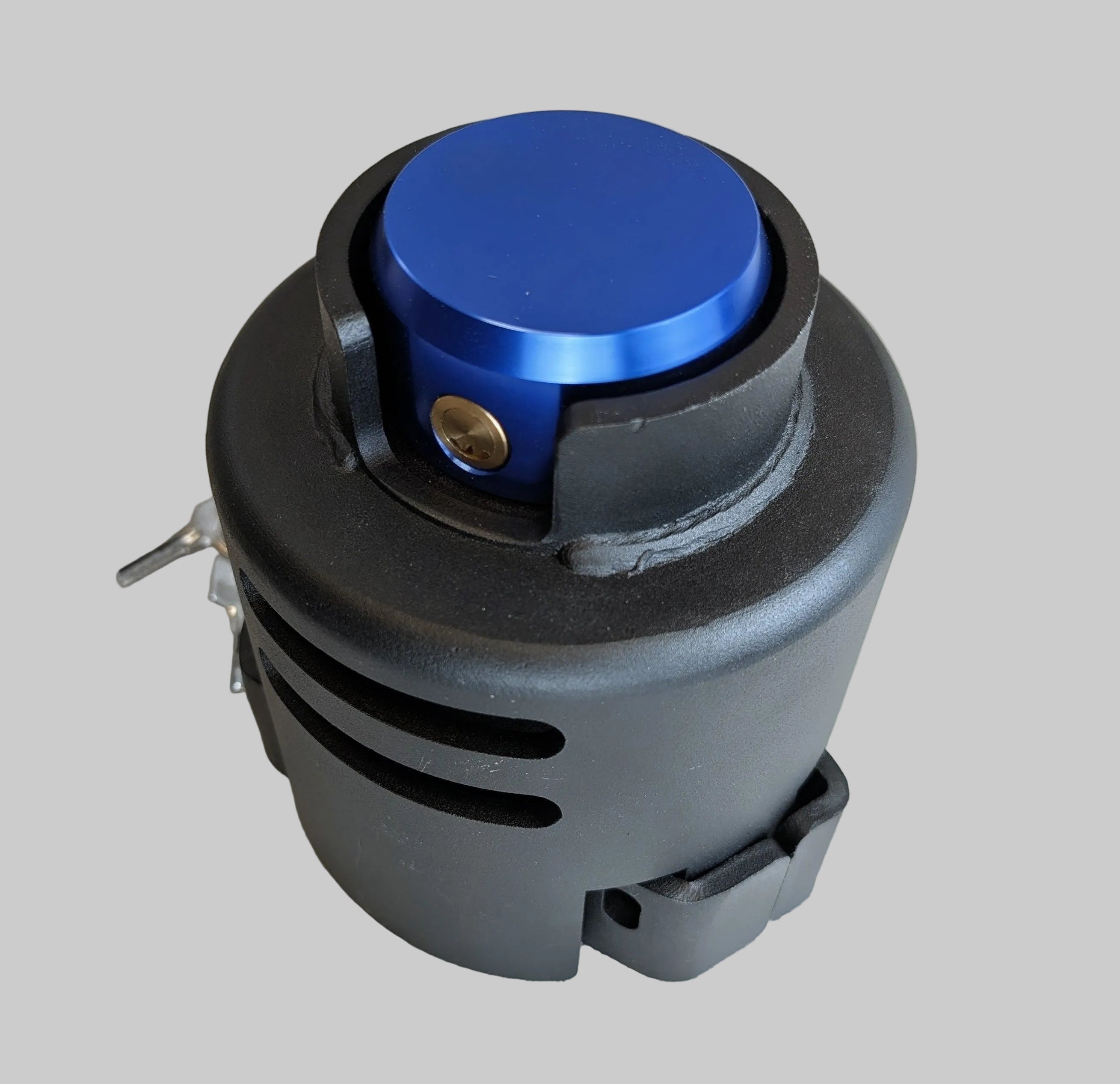 Mechanical component with blue cap and black housing on a neutral background