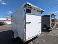 2026 AmeraLite Storm 6x10 — White and Black units side by side at AAA Trailer, both showing rear spoiler with loading lights