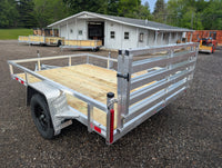 Silver Ox 7x10 Folding Gate Trailer — passenger-side rear quarter view showing gate latch hardware, LED side marker and corner post weld detail | AAA Trailer Howell MI