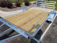 Silver Ox flat deck trailer — full-width pressure-treated deck with no side rails