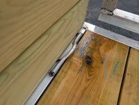 Silver Ox 6x12 Woodside Trailer — closeup of woodside board wall junction, aluminum extrusion channel and treated wood deck connection detail