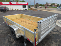 Silver Ox 6x12 Woody Aluminum Utility Trailer with Folding Ramp Gate — driver-side rear quarter at AAA Trailer Howell MI showing wood sides, aluminum frame and gate latch