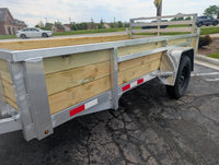 Silver Ox 6x12 Woodside Trailer — interior angle showing treated wood deck boards, aluminum side extrusions and woodside wall boards