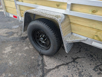 Silver Ox 6x12 Woody Trailer — axle and wheel closeup showing 205/75R15 radial ST tire on black mod wheel with diamond plate aluminum fender | AAA Trailer