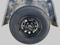 Taskmaster Provider ST205/75R15 tire and black steel wheel assembly - alternate angle | AAA Trailer